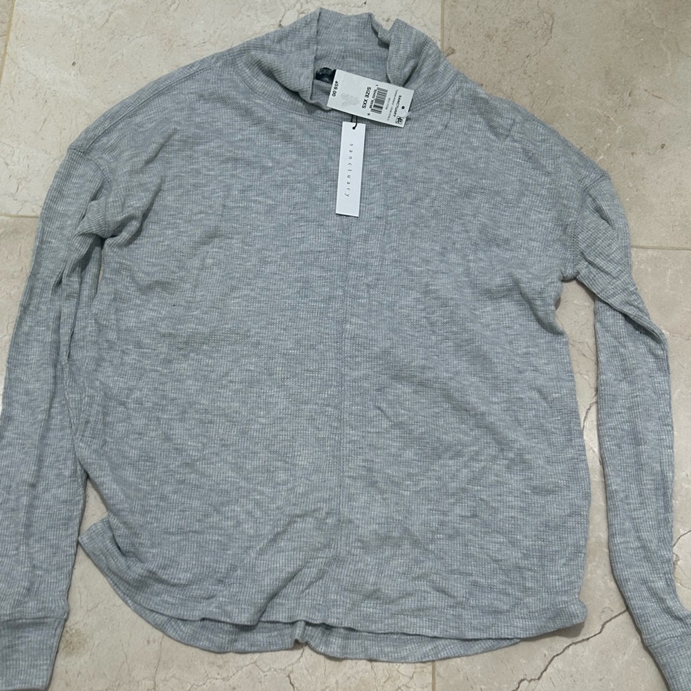 grey long sleeve shirt with neck cover kinda like a turtle neck
